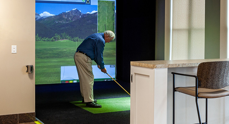 man playing indoor golf